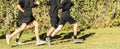 Group of boys wearing black running on grass