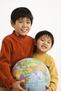 Boys holding globe