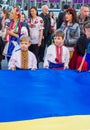 Boys holding large Ukrainian flag