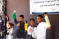 Boys holding puppets stuffed dolls and acting a play on stage