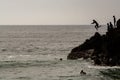 Boys jumping to the water in Ribeira de Ilhas Beach in Ericeira