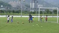 Boys kicking football on the sports field