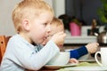 Boys kids children eating corn flakes breakfast meal at the table