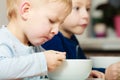 Boys kids children eating corn flakes breakfast meal at the table