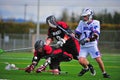 Boys Lacrosse players going down Royalty Free Stock Photo