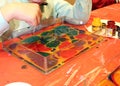 The boys are mading a bright painting with paints