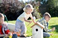 Boys make a birdhouse for the birds in the garden of a summer sunny day Royalty Free Stock Photo