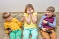 Boys offend their sister, two child brothers laugh at their sister Royalty Free Stock Photo