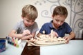 Boys painting model of a warship