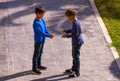 Boys play game rock paper scissor on sunny day in the yard Royalty Free Stock Photo