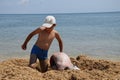 Boys play together on the sandy beach Royalty Free Stock Photo