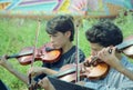 Boys play violin on