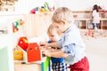 Boys play with wooden toys