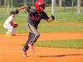 Boys playing baseball, running to base