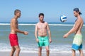 3 boys playing beach volleyball Royalty Free Stock Photo