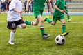 Boys playing football soccer game on sports field Royalty Free Stock Photo