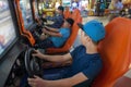 Boys playing game arcade Racing car Royalty Free Stock Photo