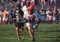 Boys playing in a high school lacrosse game Royalty Free Stock Photo