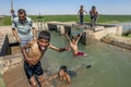 Boys playing in an irrigation channel near Harran in Turkey.