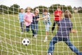Boys playing soccer in park Royalty Free Stock Photo