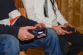 Boys are playing Sony PlayStation. Boy playing with a joystick. A boy enjoy playing game on Sony PlayStation at home.