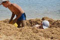 The boys are playing together on a sandy beach by the sea Royalty Free Stock Photo