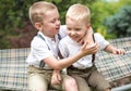 The two brothers rest,telling secrets in his ear.Boys ride in the hammock. Royalty Free Stock Photo