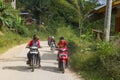 Boys riding motorbikes in Indonesia