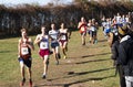 Boys running downhill chasing each other during a cross country race Royalty Free Stock Photo