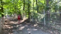 Boys running downhill in the woods running a 5K race at Sunken Meadow State Park