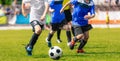 Boys running and kicking soccer ball. Close up action of boys soccer teams, aged 8-10