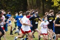 Boys running race wearing face masks and gaiters in a park