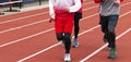 Boys running on a track in a group during practice Royalty Free Stock Photo