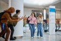 Boys scaring girls for joke, children spending time at shopping mall