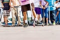 Boys with scooters and skate park. Extreme jumping on a scooter. The concept of a healthy lifestyle and sports leisure