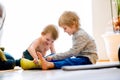 Boys sitting on the floor playing on tablet. Royalty Free Stock Photo