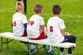 Boys Sitting on Soccer Football Wooden Bench. Kids Football Team