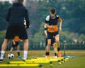 Boys' Soccer Practice Camp. Teenage boys in football training with a young coach. Teenagers on football camp