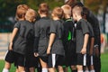 Boys Soccer Team in Huddle. Kids Sport Football Team Gathering with Coach on Sports Venue