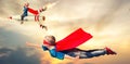 Children in superhero costumes fly and show super abilities.
