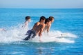 Boys surfers surfing running jumping on surfboards Royalty Free Stock Photo