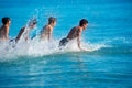 Boys surfers surfing running jumping on surfboards Royalty Free Stock Photo