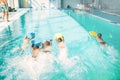 Boys swimming with plank in a pool race Royalty Free Stock Photo