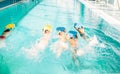 Boys swimming with plank in a pool race Royalty Free Stock Photo