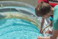 Boys take water into an inflatable pool photo