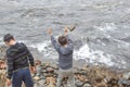 Boys Throwing Rocks Into a River Royalty Free Stock Photo