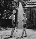 Boys under a shower in the garden