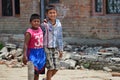 Boys walking pass collapsed building after earthquake disaster