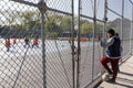 Boys watch the children play football