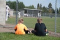 Boys watching baseball game.